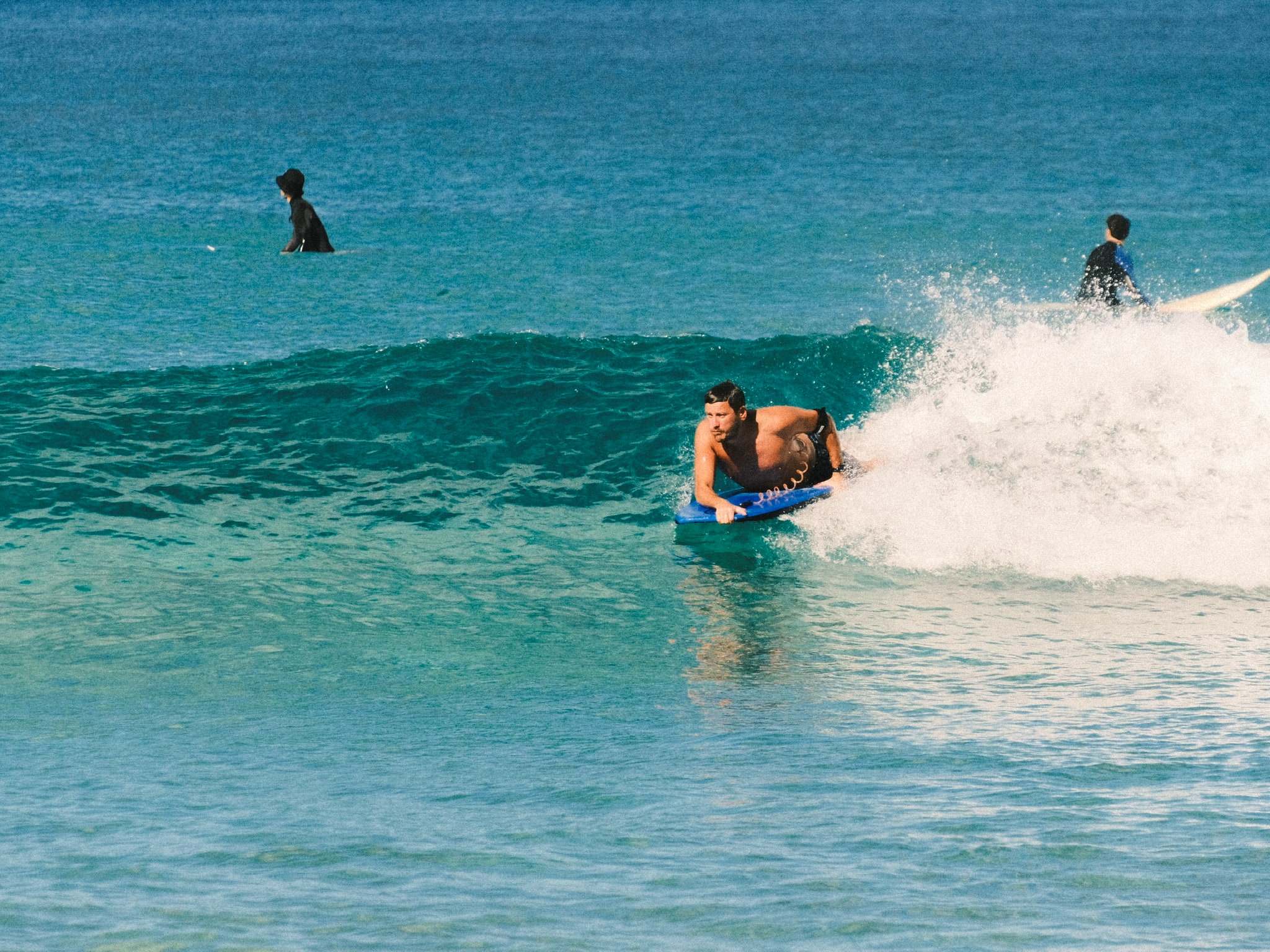 Bodyboarder dropping into a clear turquoise wave in Fuerteventura