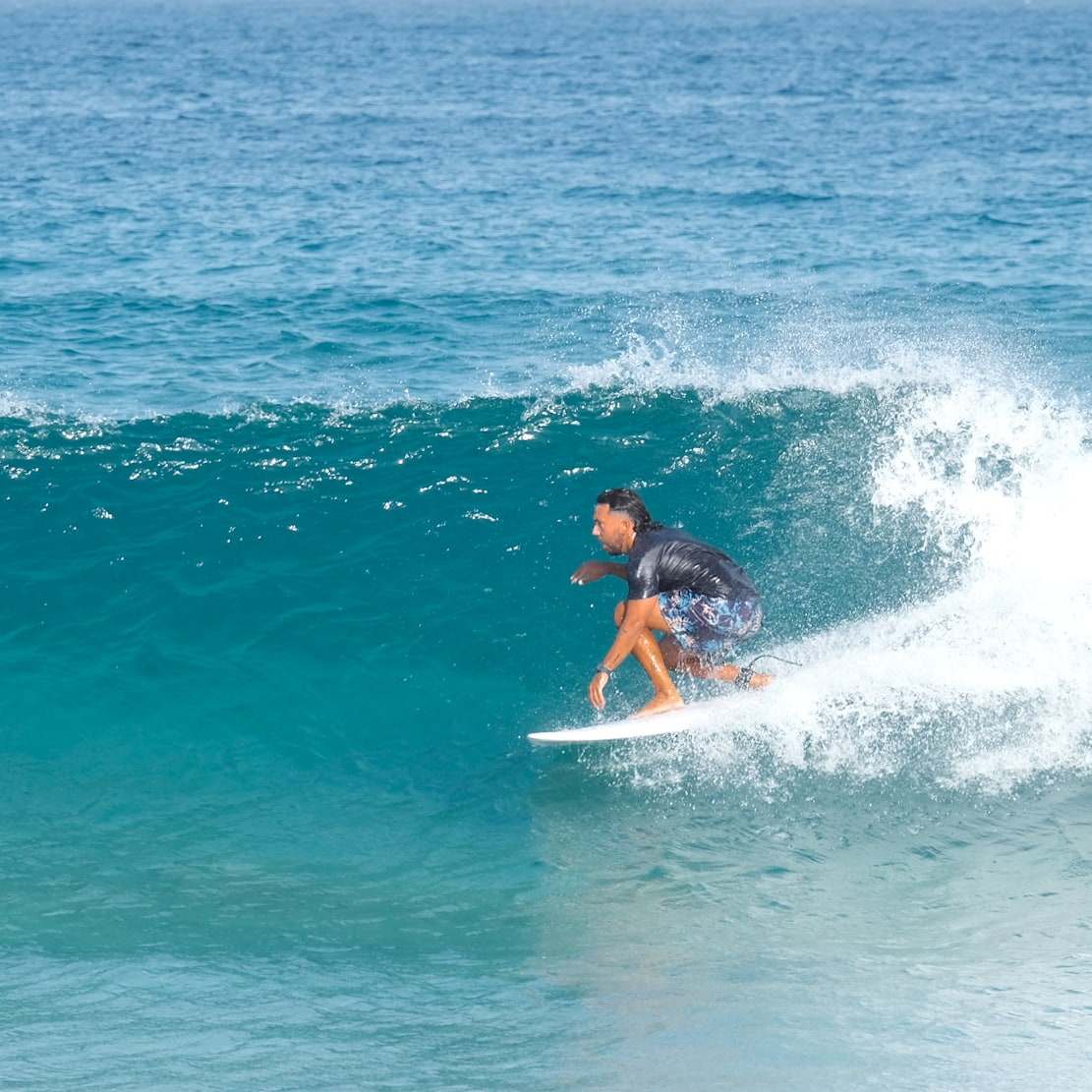 Erik surfing a turquoise wave