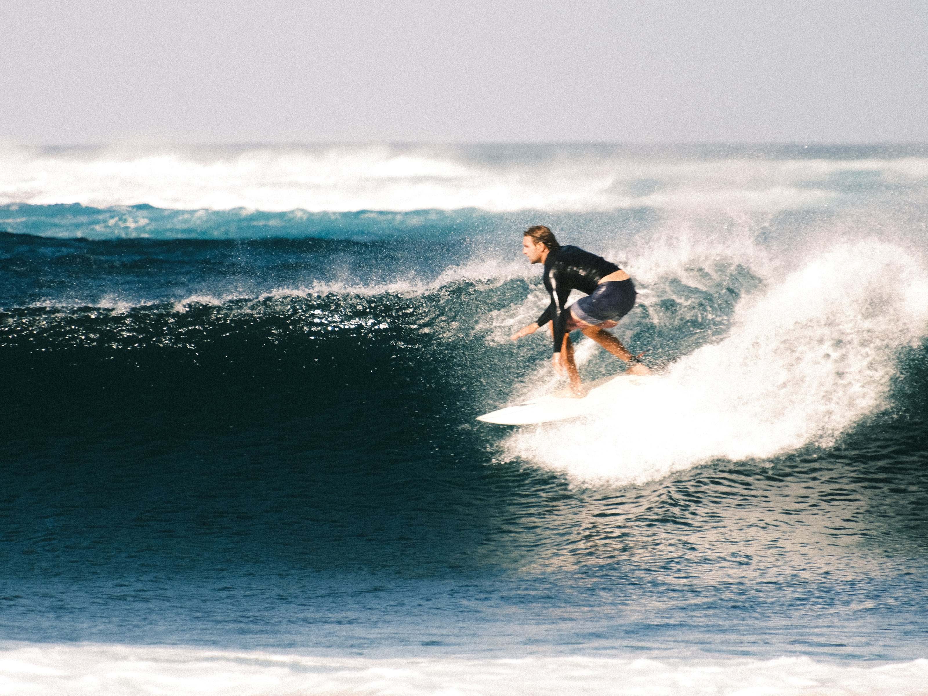 Surfer in a deep blue barrel, shot by a surf photographer in Fuerteventura